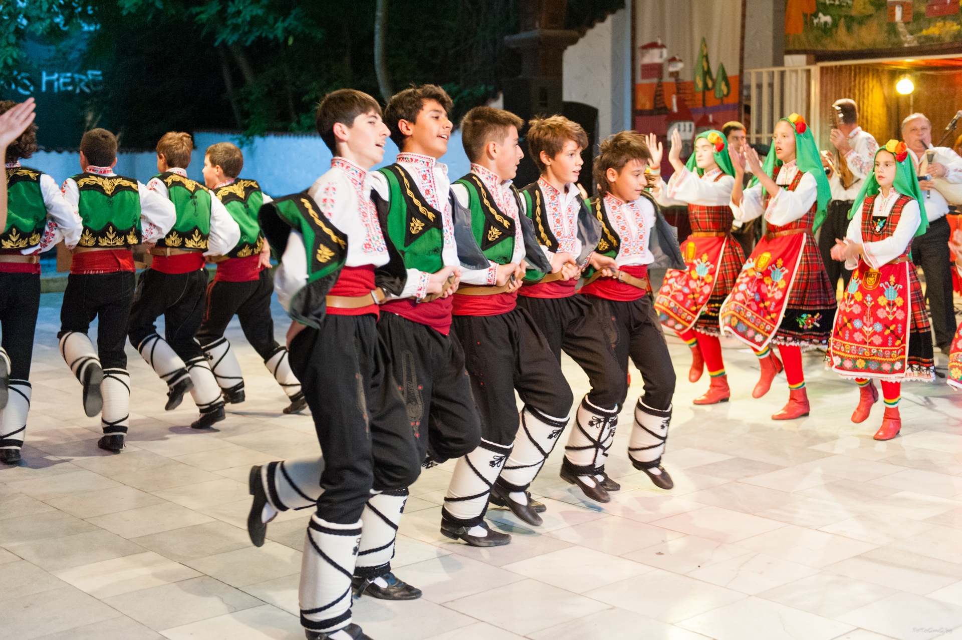 A folk dance ensemble performing in traditional costumes